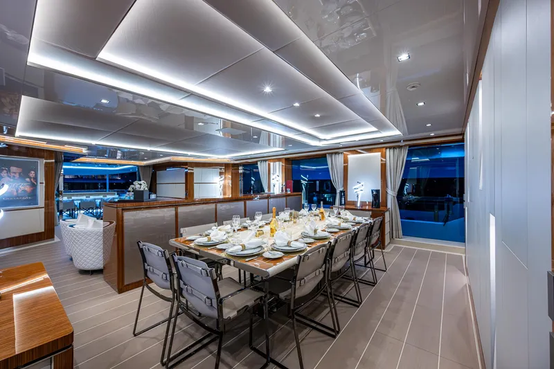 Goldeneye Yacht Photos Pics Luxurious dining area on 2020 Mangusta 54 Gransport yacht, elegantly set for a formal dinner.