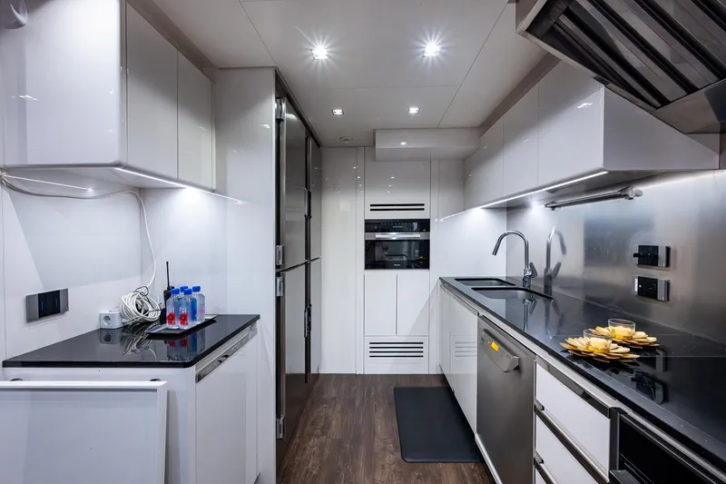 Goldeneye Yacht Photos Pics Modern kitchen interior on 2020 Mangusta 54 Gransport yacht, featuring sleek design and appliances.