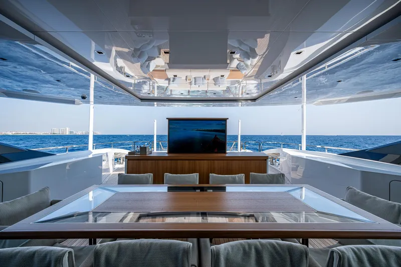 Goldeneye Yacht Photos Pics Luxurious 2020 Mangusta 54 Gransport yacht interior with ocean view and elegant dining area.