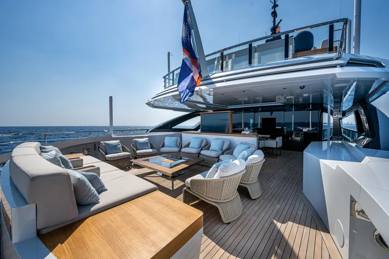 Goldeneye Yacht Photos Pics Luxurious 2020 Mangusta 54 Gransport yacht deck with elegant seating and ocean view.