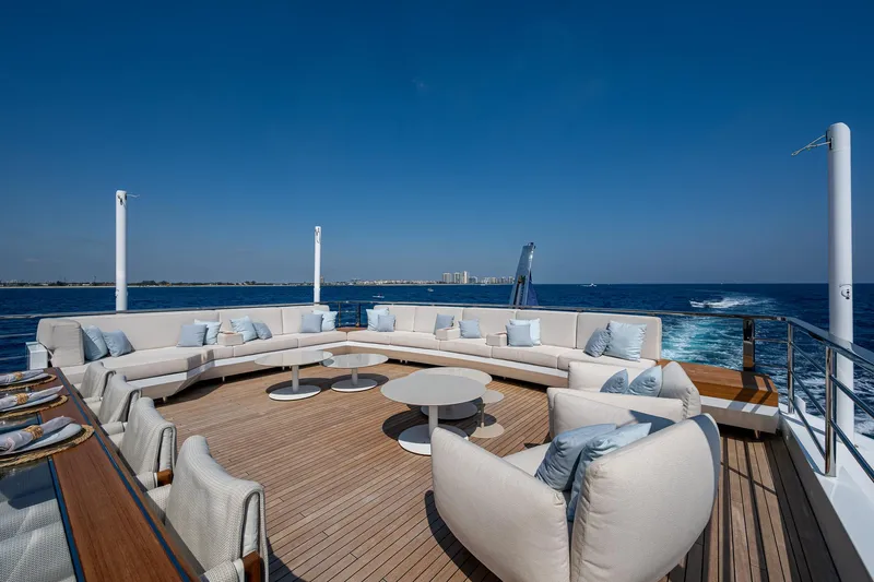 Goldeneye Yacht Photos Pics Luxurious deck of 2020 Mangusta 54 Gransport yacht with elegant seating and ocean view.