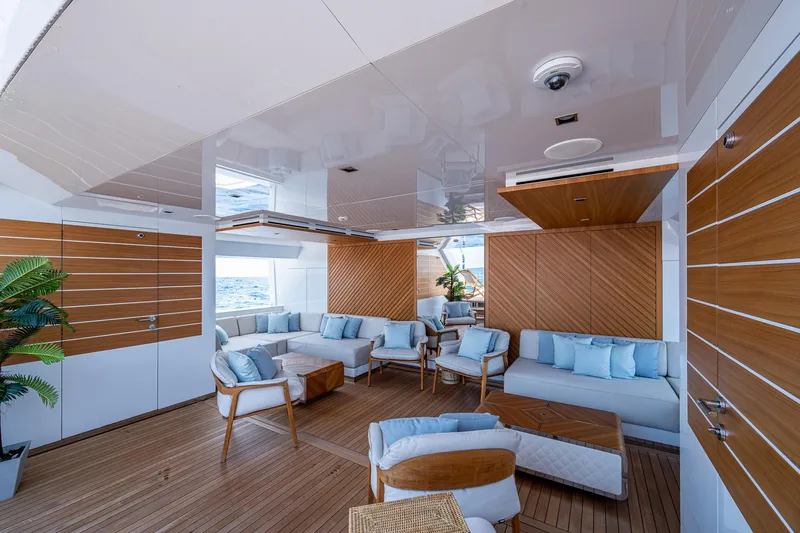 Goldeneye Yacht Photos Pics Luxurious interior of 2020 Mangusta 54 Gransport yacht with modern seating and wood accents.