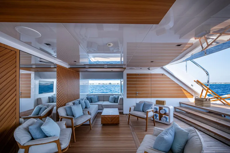 Goldeneye Yacht Photos Pics Luxurious interior of 2020 Mangusta 54 Gransport yacht with elegant seating and ocean view.