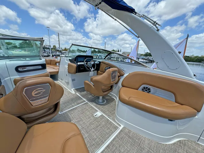  Yacht Photos Pics 2024 Crownline 290 XSS boat interior with tan leather seats and modern dashboard.