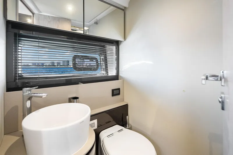  Yacht Photos Pics Modern bathroom interior on 2021 Azimut Atlantis 51 yacht, featuring sleek design and ocean view.