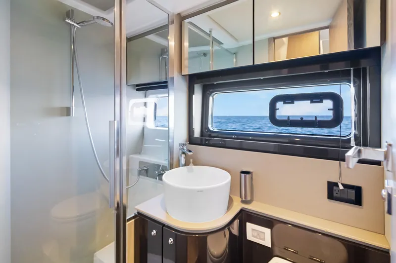 Yacht Photos Pics Luxurious bathroom interior of 2021 Azimut Atlantis 51 yacht with ocean view.