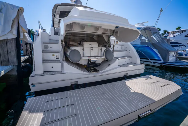  Yacht Photos Pics 2021 Azimut Atlantis 51 yacht with open garage and swim platform at marina.