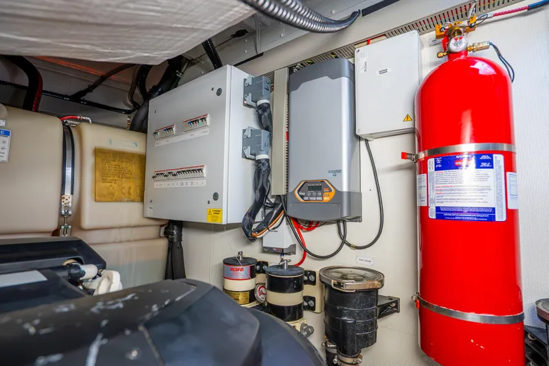  Yacht Photos Pics Engine room of 2021 Azimut Atlantis 51 yacht with electrical panels and fire extinguisher.