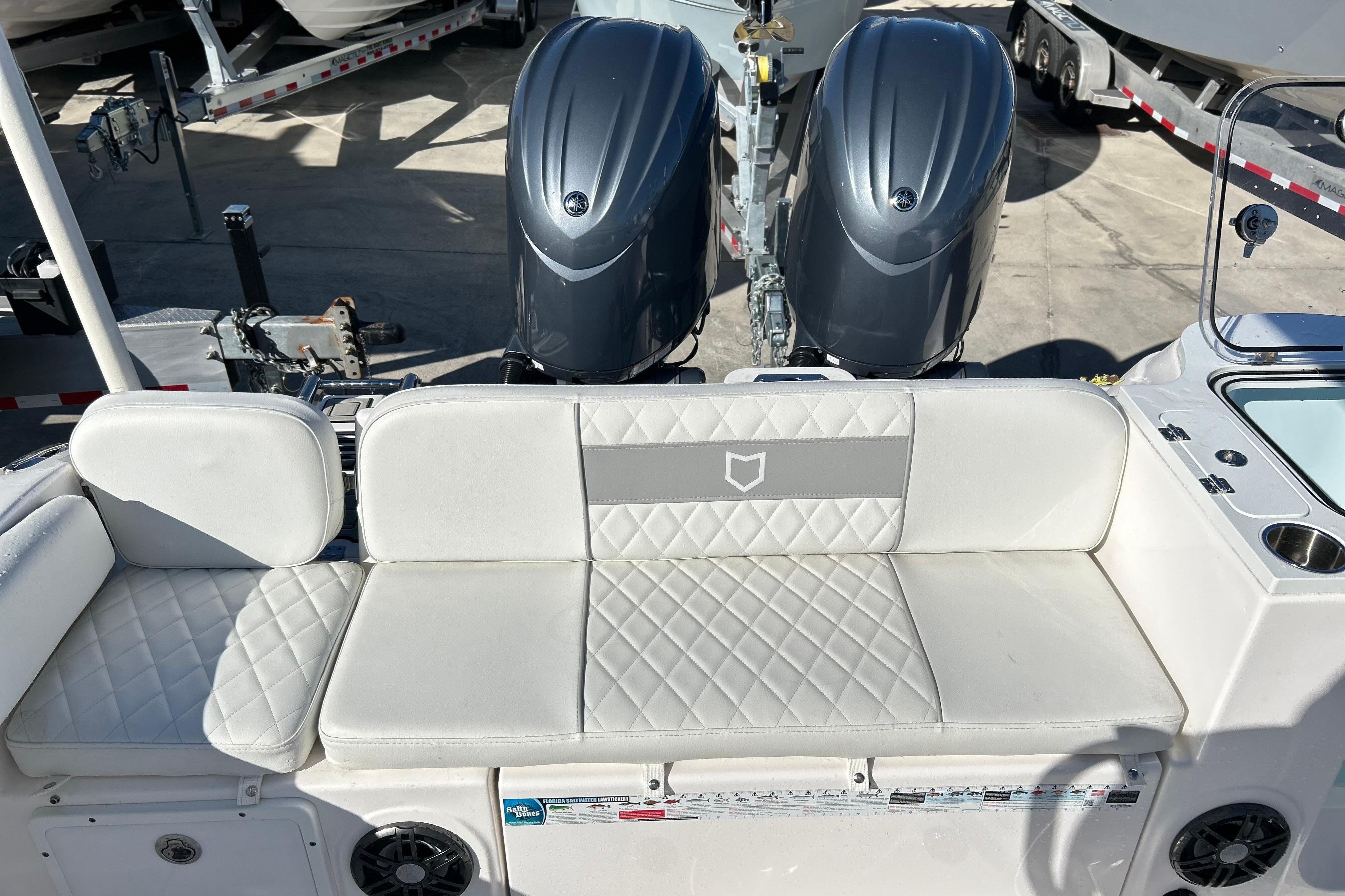 2024 Sea Fox 268 Commander boat interior with dual engines and cushioned seating.