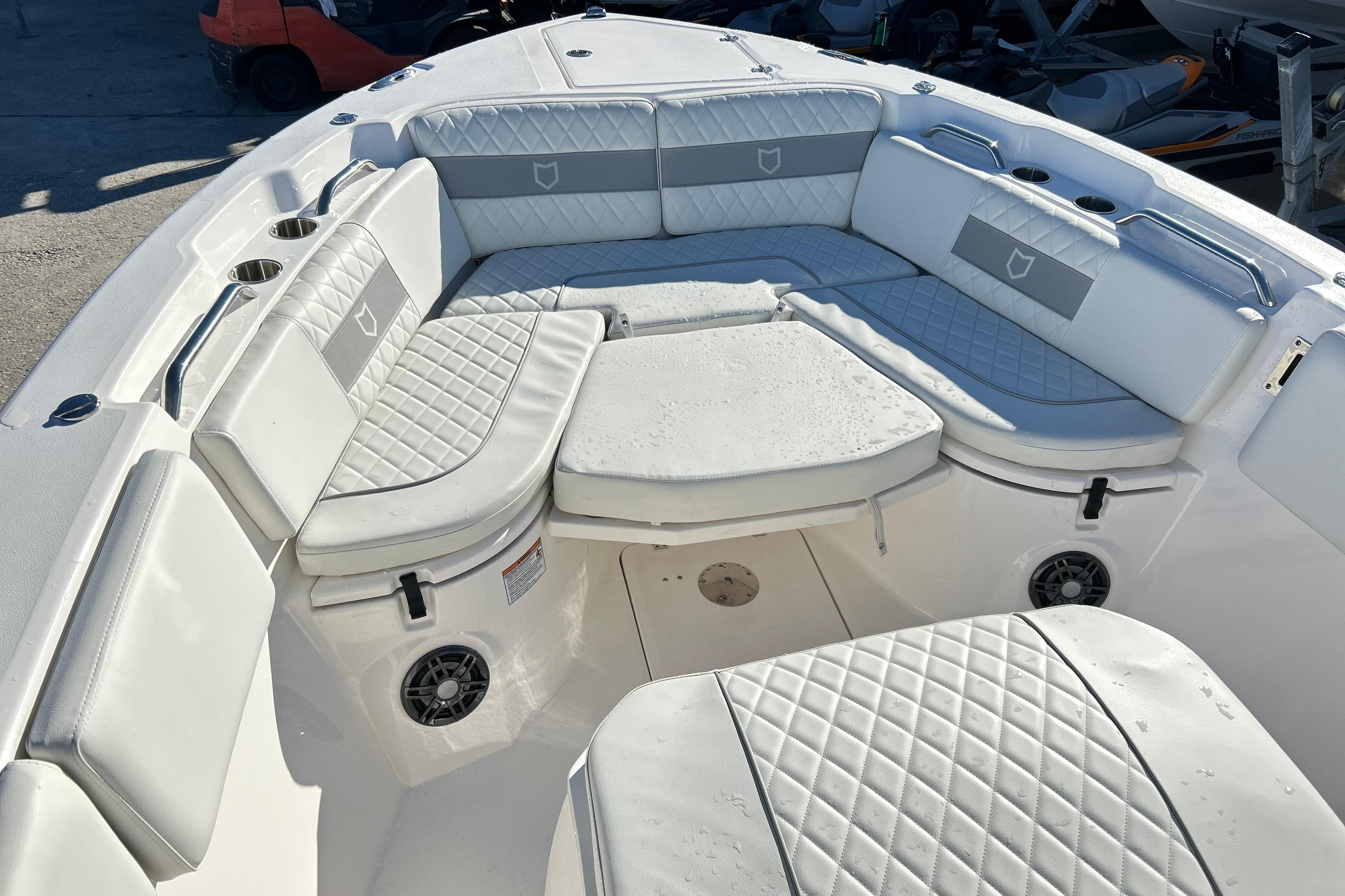 2024 Sea Fox 268 Commander boat interior with cushioned seating and cup holders.