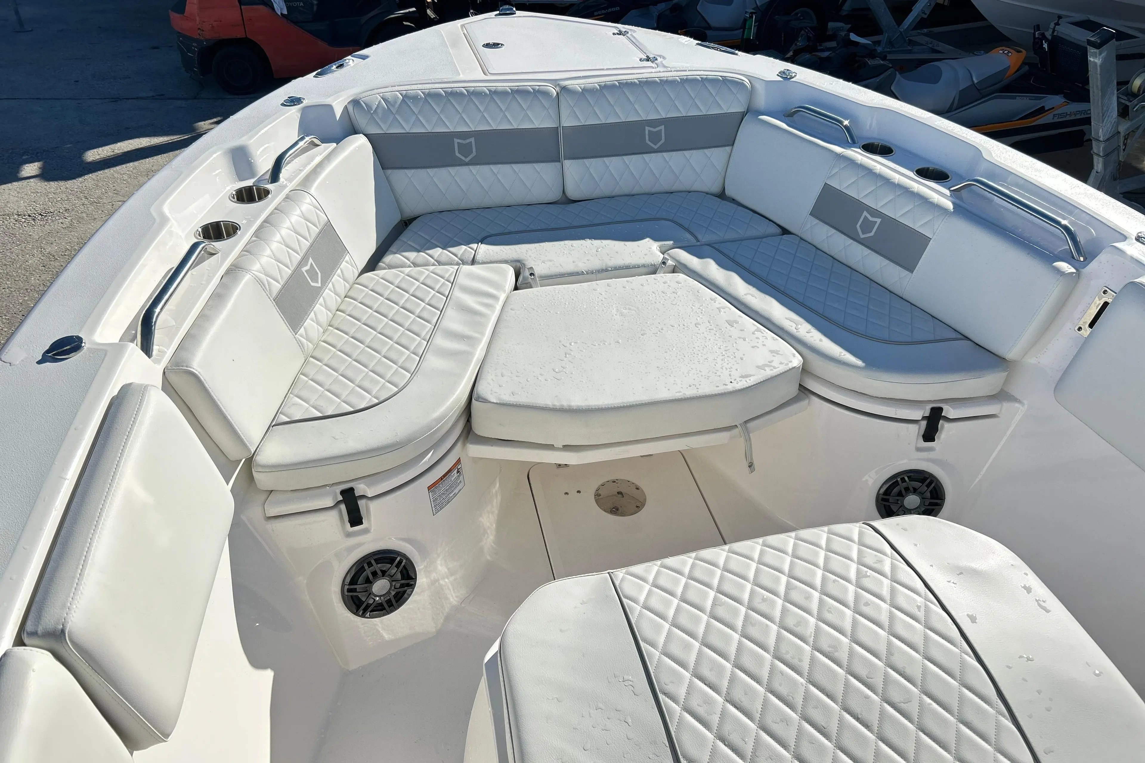 2024 Sea Fox 268 Commander boat interior with cushioned seating and cup holders.