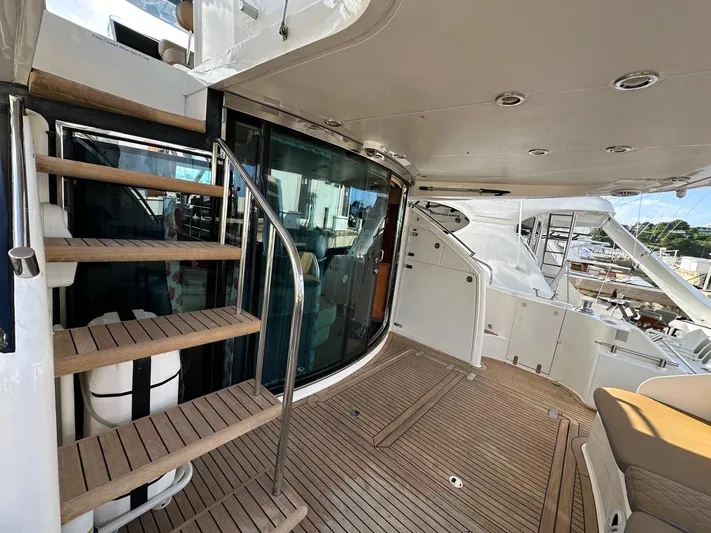  Yacht Photos Pics 2006 Fairline Squadron 58 yacht deck with wooden flooring and staircase.