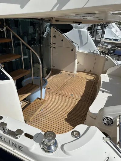  Yacht Photos Pics 2006 Fairline Squadron 58 yacht deck with wooden flooring and staircase.