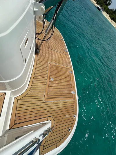  Yacht Photos Pics 2006 Fairline Squadron 58 yacht with teak deck on turquoise water.