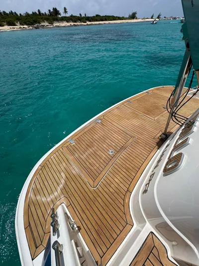  Yacht Photos Pics Fairline Squadron 58 yacht, 2006 model, with teak deck near turquoise waters and sandy beach.