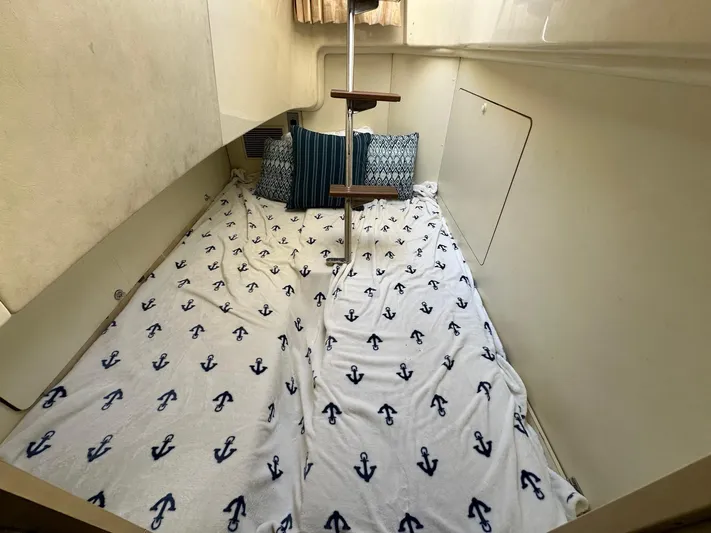  Yacht Photos Pics Cozy cabin interior of 2006 Fairline Squadron 58 yacht with anchor-patterned bedding.