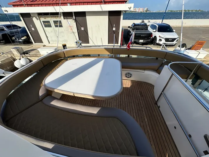  Yacht Photos Pics 2006 Fairline Squadron 58 yacht deck with seating and table, docked at marina.