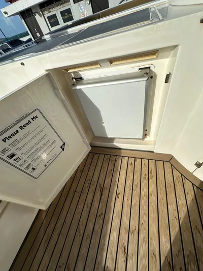  Yacht Photos Pics 2006 Fairline Squadron 58 yacht interior with wooden flooring and storage compartment.