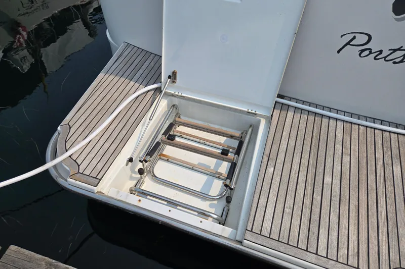 Wa Yacht Photos Pics Beneteau Swift Trawler 52, 2012 model, featuring a foldable swim ladder on teak deck.