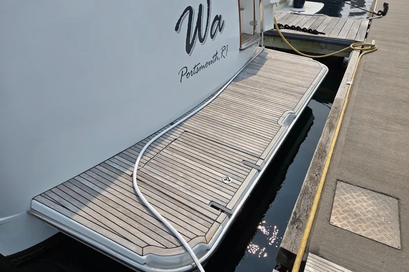 Wa Yacht Photos Pics 2012 Beneteau Swift Trawler 52 docked, featuring a wooden swim platform.