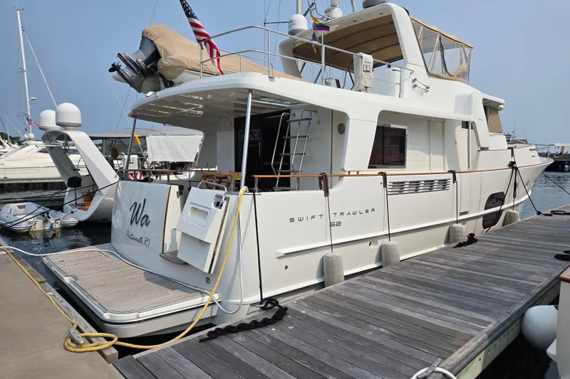 Wa Yacht Photos Pics 2012 Beneteau Swift Trawler 52 docked at a marina, rear view.