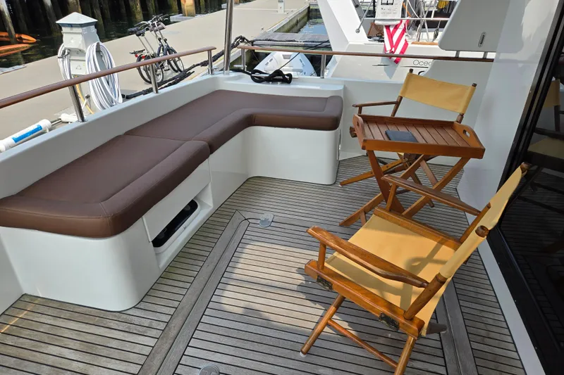 Wa Yacht Photos Pics 2012 Beneteau Swift Trawler 52 deck with seating and wooden chairs.