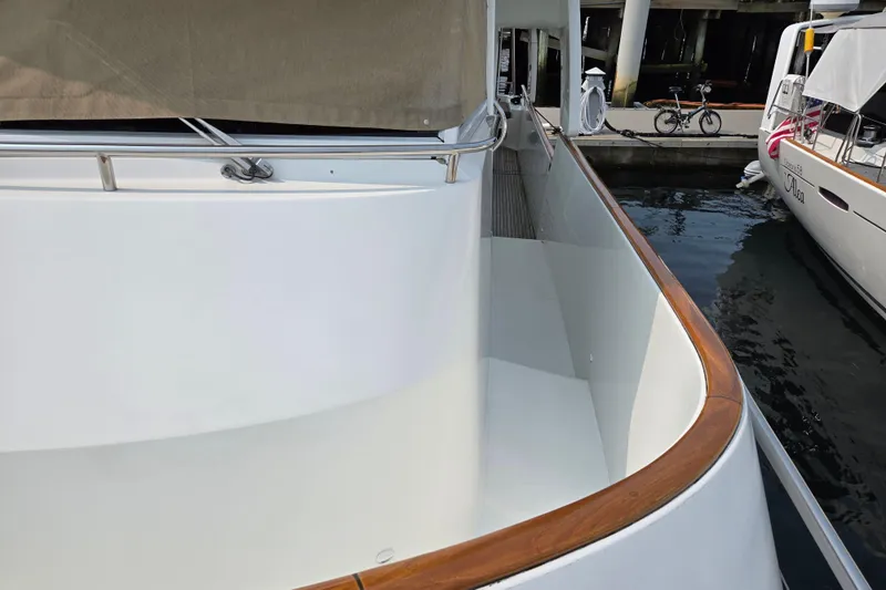 Wa Yacht Photos Pics 2012 Beneteau Swift Trawler 52 docked, showcasing sleek side deck and polished wood railing.