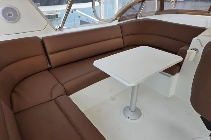Wa Yacht Photos Pics Interior of 2012 Beneteau Swift Trawler 52 with brown seating and white table.