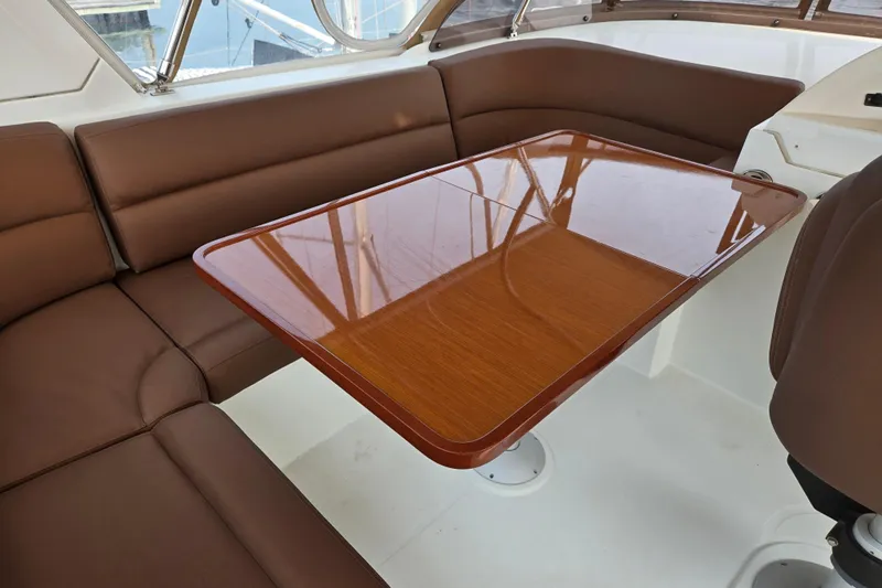 Wa Yacht Photos Pics Luxurious interior of 2012 Beneteau Swift Trawler 52 with brown seating and wooden table.