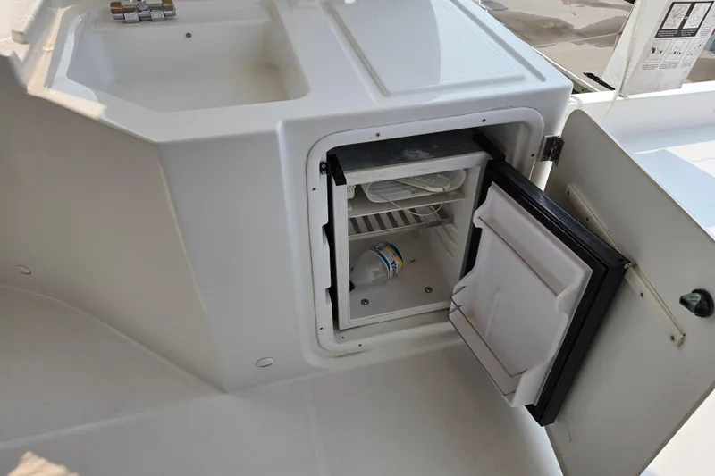 Wa Yacht Photos Pics Open mini fridge on 2012 Beneteau Swift Trawler 52 yacht, showing interior storage space.