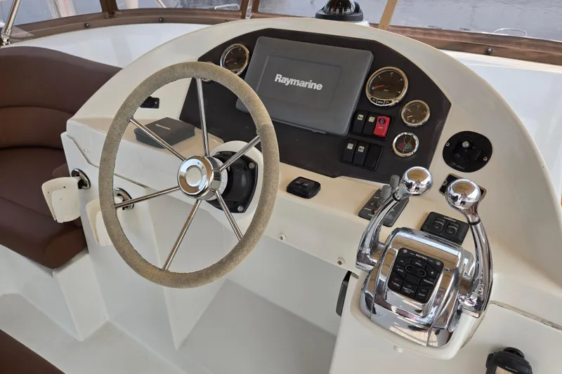 Wa Yacht Photos Pics Helm of 2012 Beneteau Swift Trawler 52 with Raymarine navigation system and dual throttle controls.