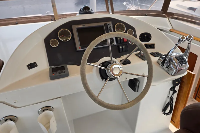 Wa Yacht Photos Pics Helm of 2012 Beneteau Swift Trawler 52 with steering wheel and control panel.