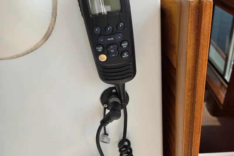 Wa Yacht Photos Pics Radio handset on 2012 Beneteau Swift Trawler 52, mounted near wooden panel.