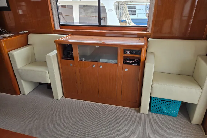 Wa Yacht Photos Pics Interior of 2012 Beneteau Swift Trawler 52 with wooden cabinetry and cream seating.