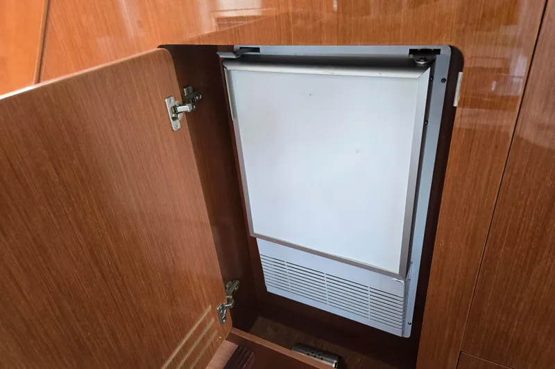 Wa Yacht Photos Pics Built-in refrigerator on 2012 Beneteau Swift Trawler 52, wooden cabinet open.
