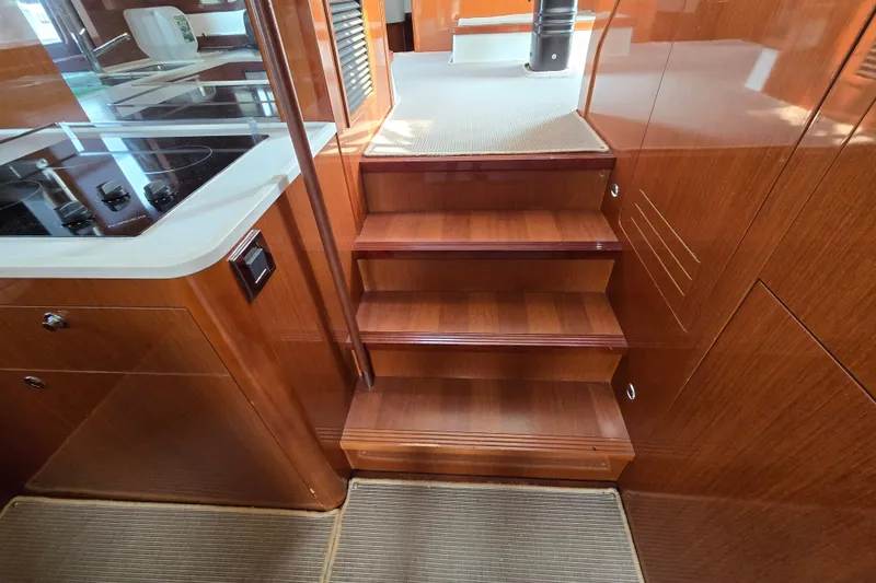Wa Yacht Photos Pics Interior stairs of 2012 Beneteau Swift Trawler 52 with wooden finish and modern design.