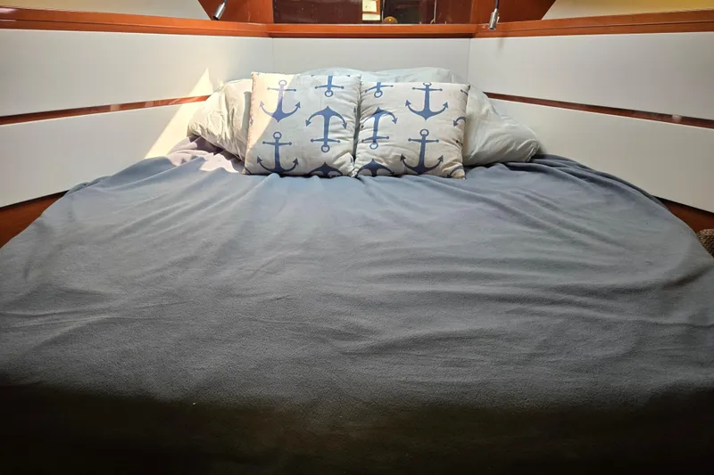 Wa Yacht Photos Pics Cozy cabin bed in 2012 Beneteau Swift Trawler 52 with anchor-themed pillows.