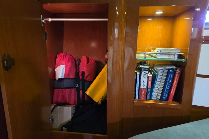 Wa Yacht Photos Pics Cabinet on 2012 Beneteau Swift Trawler 52 with life jackets and nautical books.