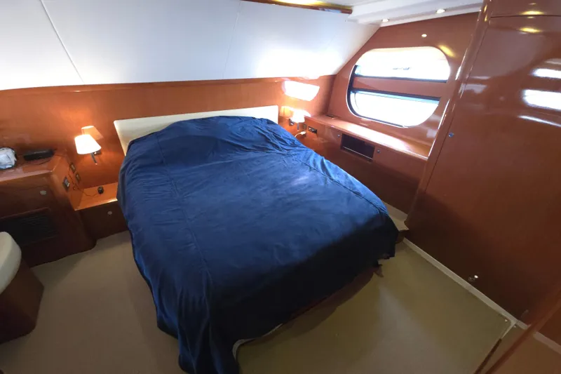 Wa Yacht Photos Pics Luxurious cabin interior of 2012 Beneteau Swift Trawler 52 with blue bedding and wooden finish.