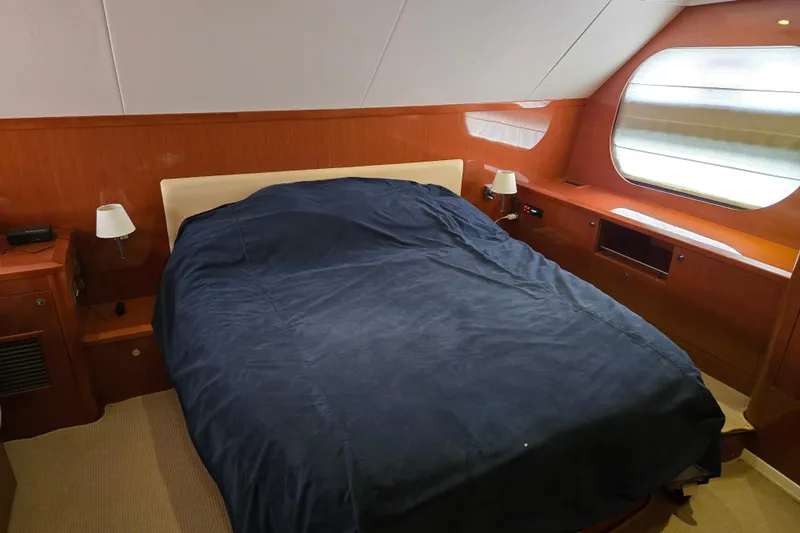 Wa Yacht Photos Pics Luxurious bedroom interior of 2012 Beneteau Swift Trawler 52 with wooden finish and large window.