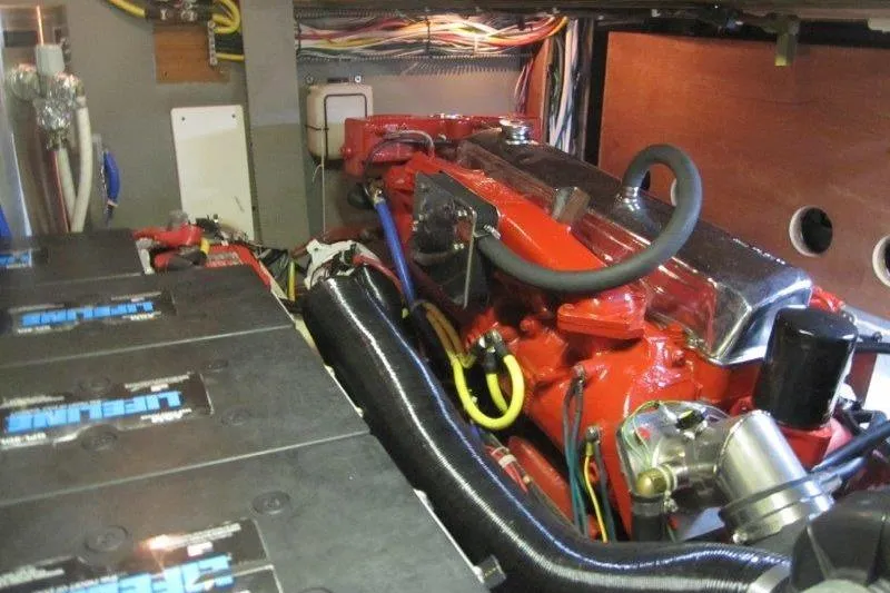 Bella Yacht Photos Pics Engine room of a 1983 Nauticat 43 sailboat, featuring a red engine and wiring.