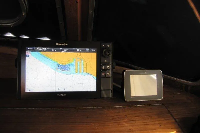 Bella Yacht Photos Pics Navigation equipment on 1983 Nauticat 43 sailboat, featuring Raymarine display and chartplotter.