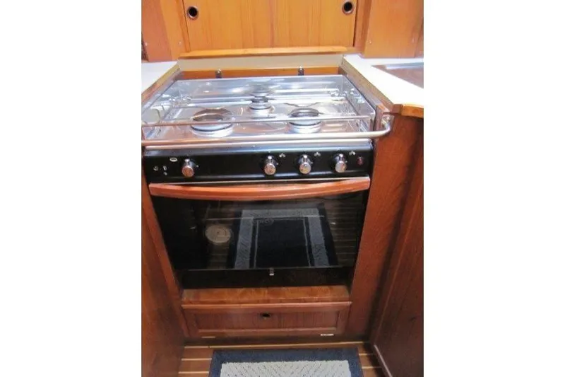 Bella Yacht Photos Pics Stove and oven in 1983 Nauticat 43 yacht kitchen, featuring wooden cabinetry.