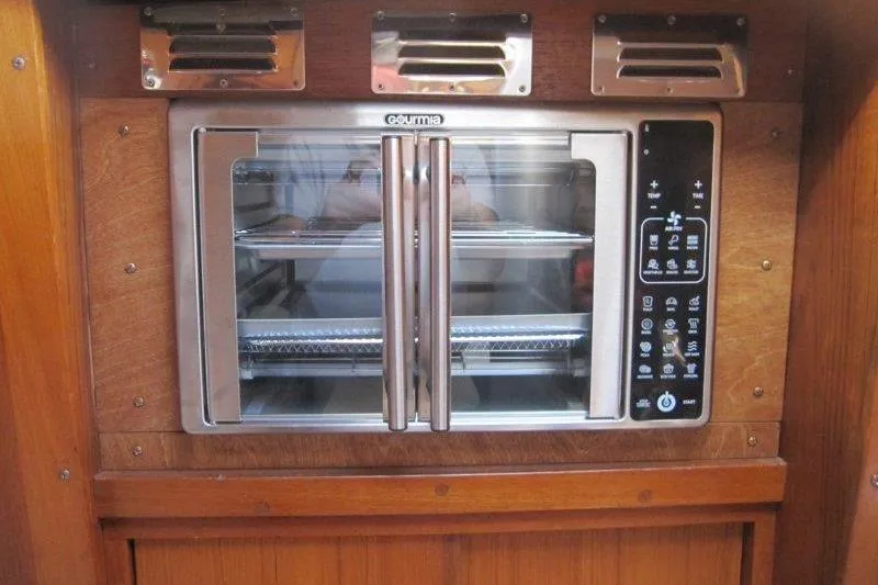 Bella Yacht Photos Pics Built-in oven in 1983 Nauticat 43 yacht kitchen, featuring stainless steel design and control panel.