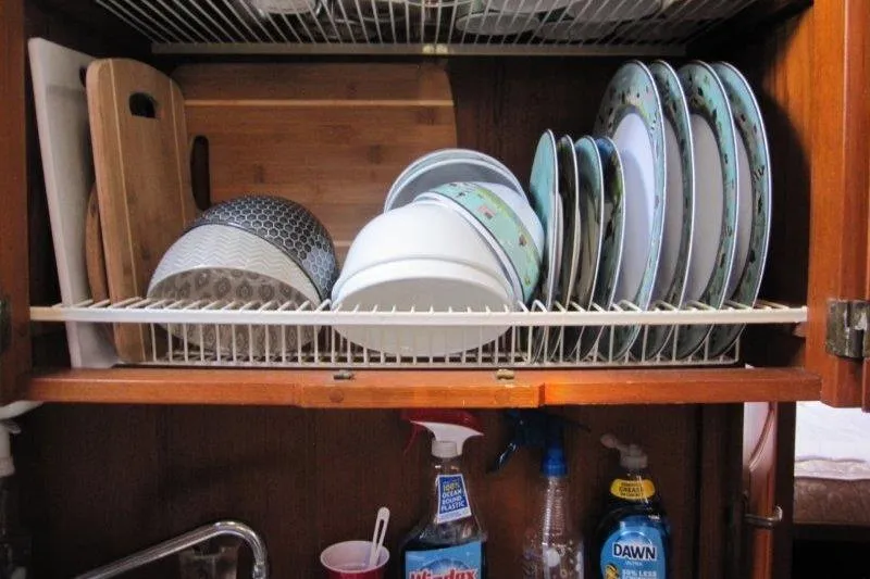 Bella Yacht Photos Pics Dishes and cleaning supplies in a Nauticat 43 yacht kitchen cabinet, 1983 model.