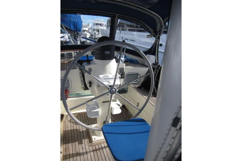 Bella Yacht Photos Pics Cockpit of 1983 Nauticat 43 sailboat with steering wheel and blue seating.
