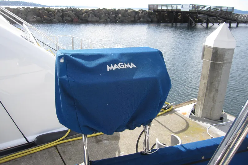Bella Yacht Photos Pics Blue Magma grill cover on 1983 Nauticat 43 yacht docked by the water.