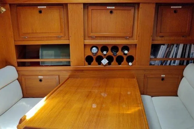 Bella Yacht Photos Pics Interior of 1983 Nauticat 43 yacht with wooden cabinetry and wine storage.