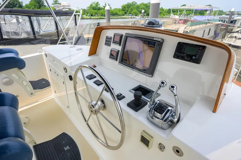 Teal Aweigh Yacht Photos Pics Helm of 2011 Grand Banks 41 Europa yacht with navigation controls and steering wheel.