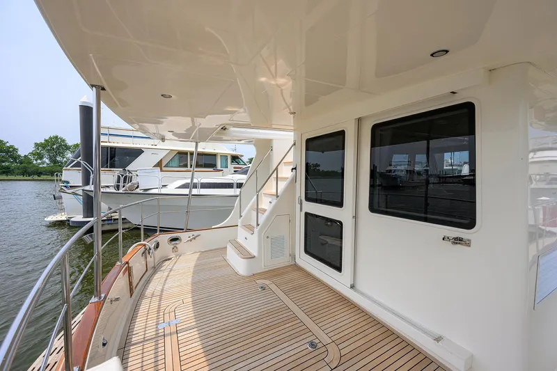 Teal Aweigh Yacht Photos Pics 2011 Grand Banks 41 Europa yacht with teak deck and sleek design, docked by the water.